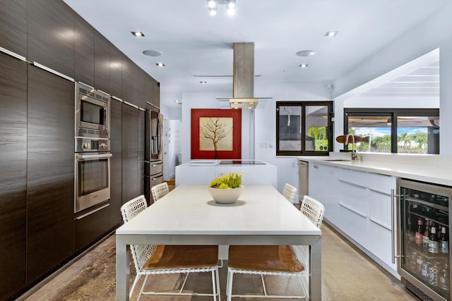 dining space with beverage cooler and sink