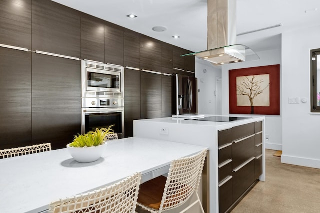 kitchen featuring dark brown cabinetry, stainless steel appliances, a kitchen island, and island range hood