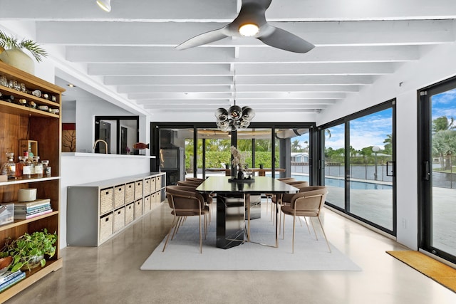 dining space with ceiling fan, a water view, a mail area, concrete floors, and beamed ceiling