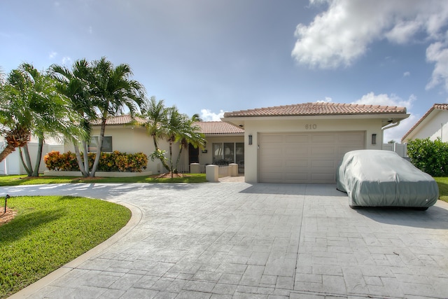 mediterranean / spanish-style house with a garage