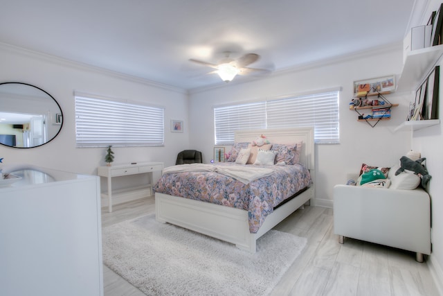 bedroom featuring ceiling fan, crown molding, and light hardwood / wood-style floors