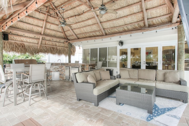 view of patio / terrace with a gazebo, an outdoor hangout area, a wet bar, and ceiling fan