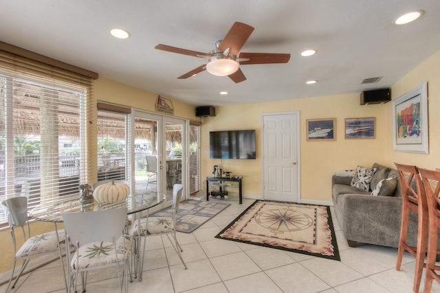 tiled living room featuring ceiling fan