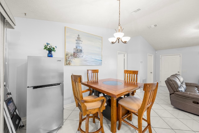 tiled dining room with lofted ceiling and a chandelier