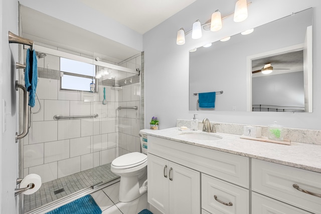 bathroom featuring ceiling fan, toilet, vanity, an enclosed shower, and tile patterned flooring