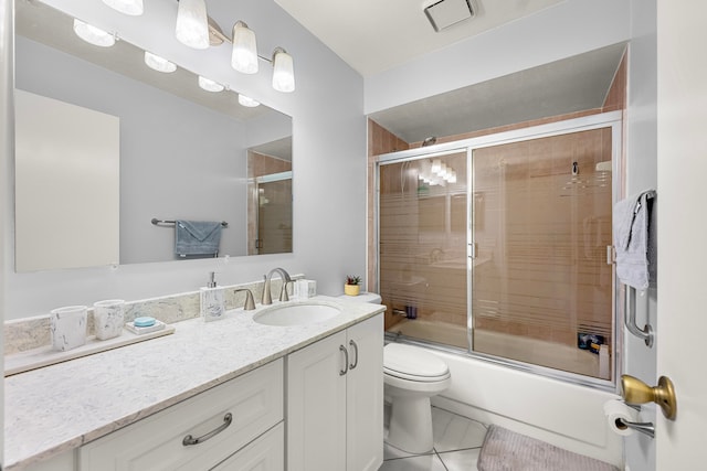 full bathroom featuring vanity, toilet, shower / bath combination with glass door, and tile patterned flooring