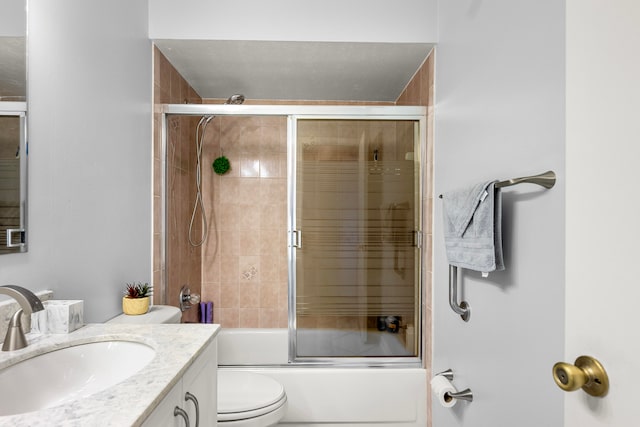 full bathroom with vanity, combined bath / shower with glass door, and toilet