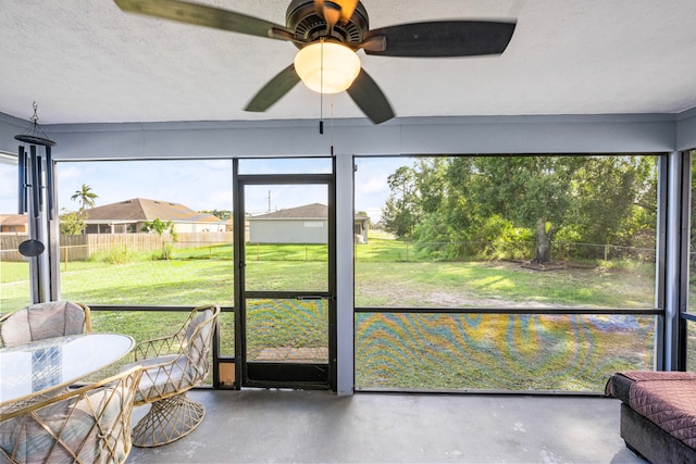 sunroom / solarium featuring ceiling fan