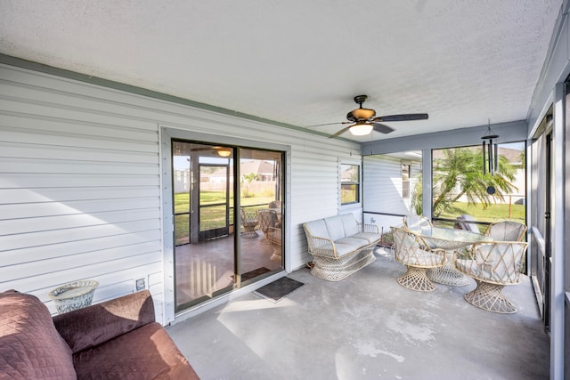 sunroom / solarium featuring ceiling fan