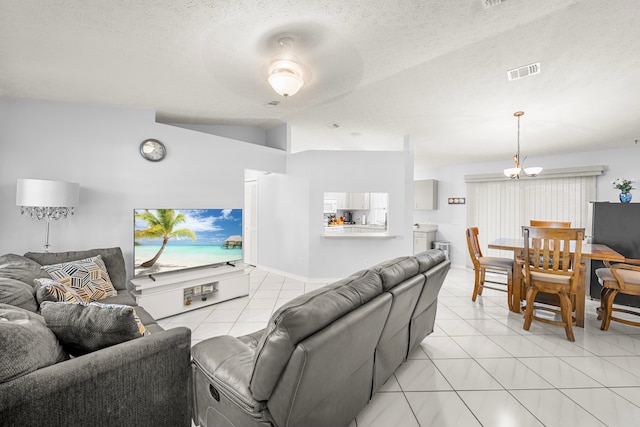 tiled living room featuring a textured ceiling, ceiling fan, and vaulted ceiling