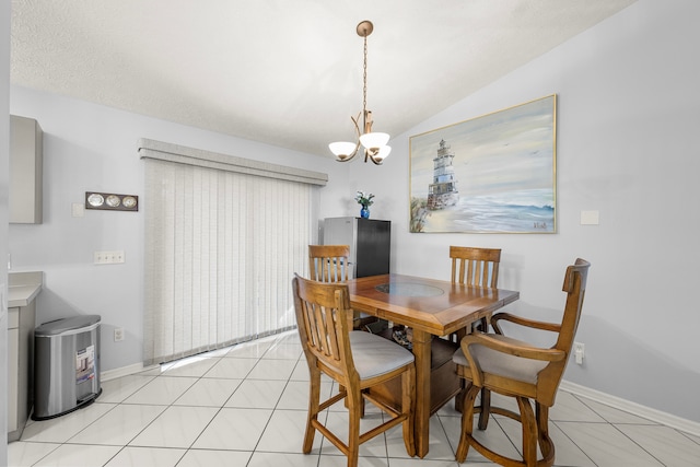 tiled dining room featuring vaulted ceiling and an inviting chandelier