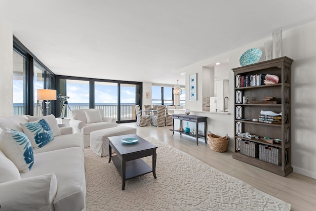 tiled living room with a water view and a wall of windows