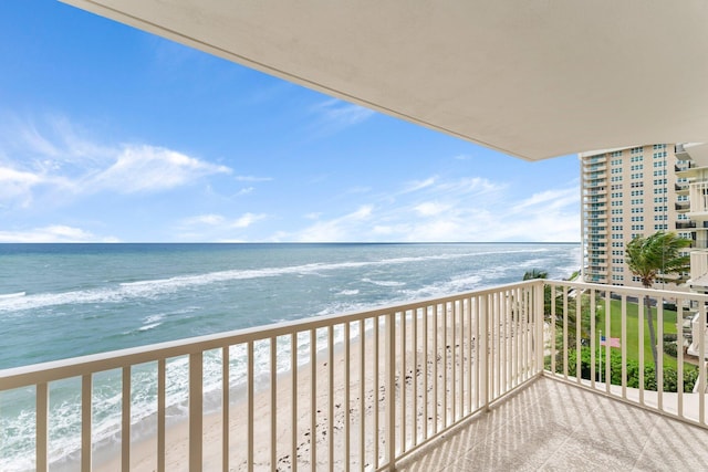 balcony with a view of the beach and a water view