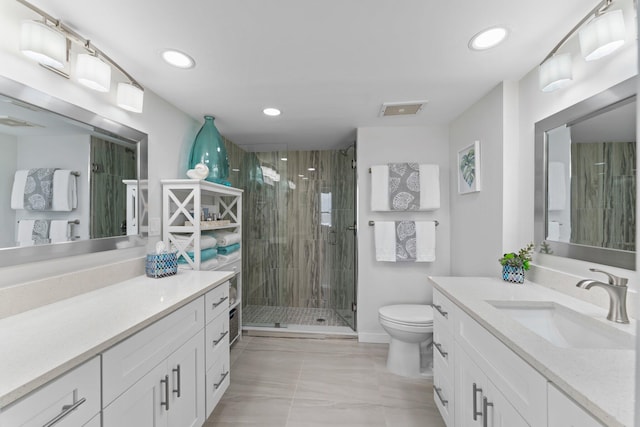 bathroom featuring vanity, toilet, and a shower with door