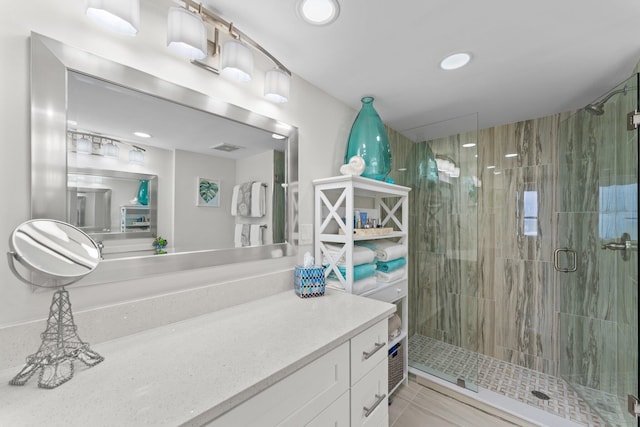 bathroom with a shower with door and vanity