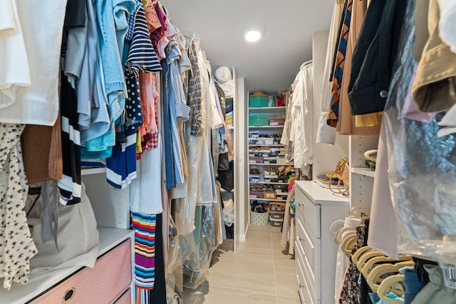 spacious closet featuring light tile patterned floors