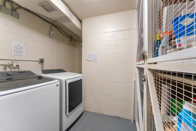 washroom with washing machine and clothes dryer