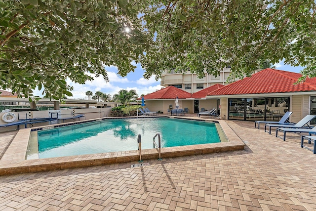 view of swimming pool featuring a patio area