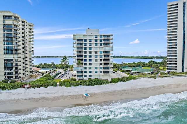 view of property with a water view and a view of the beach