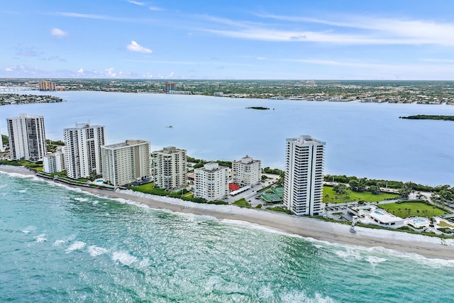 drone / aerial view with a water view and a beach view