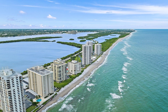 drone / aerial view featuring a water view and a beach view