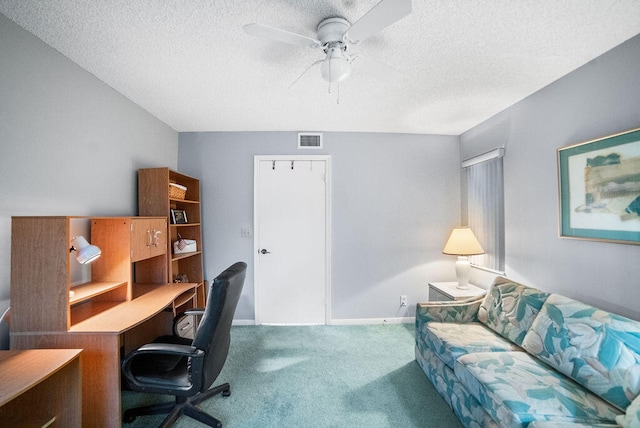 office area with carpet flooring, ceiling fan, and a textured ceiling