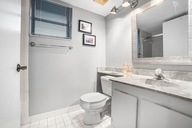 bathroom featuring tile patterned flooring, vanity, toilet, and a shower with shower door