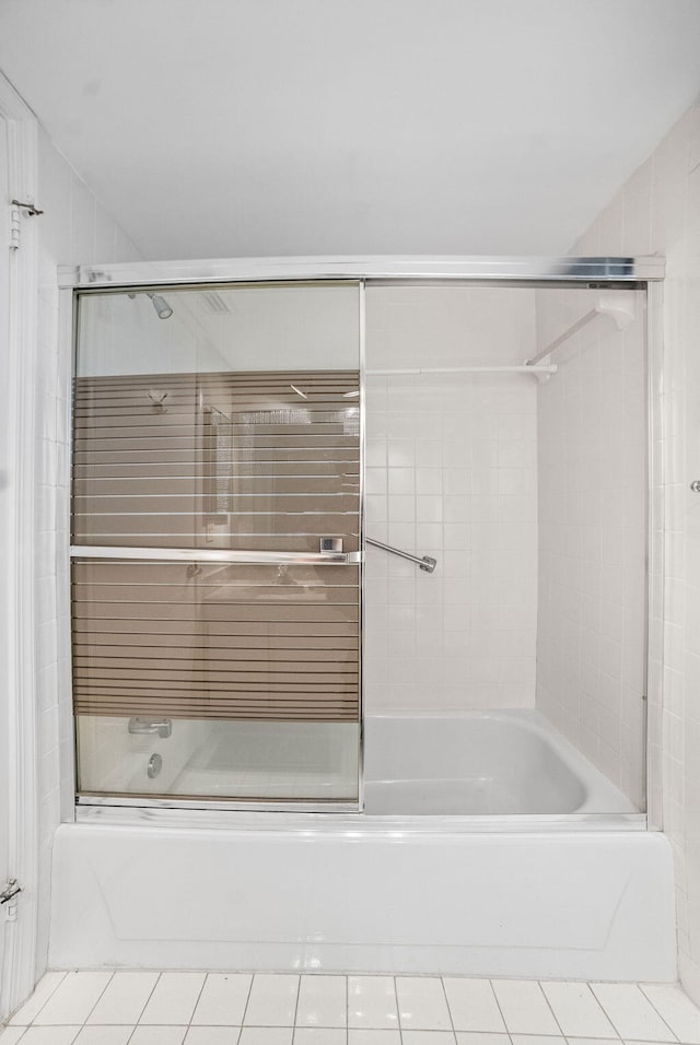 bathroom with tile patterned floors and shower / bath combination with glass door