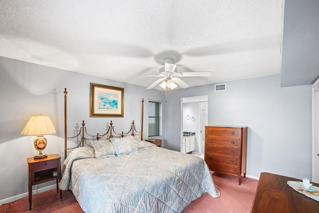 carpeted bedroom featuring ceiling fan and a textured ceiling