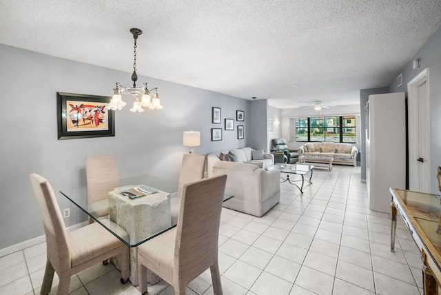 tiled dining area featuring ceiling fan with notable chandelier and a textured ceiling