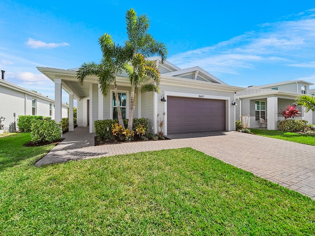 ranch-style house featuring a front yard and a garage