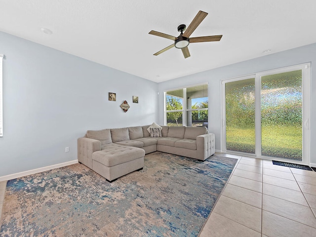 living room with tile patterned flooring and ceiling fan