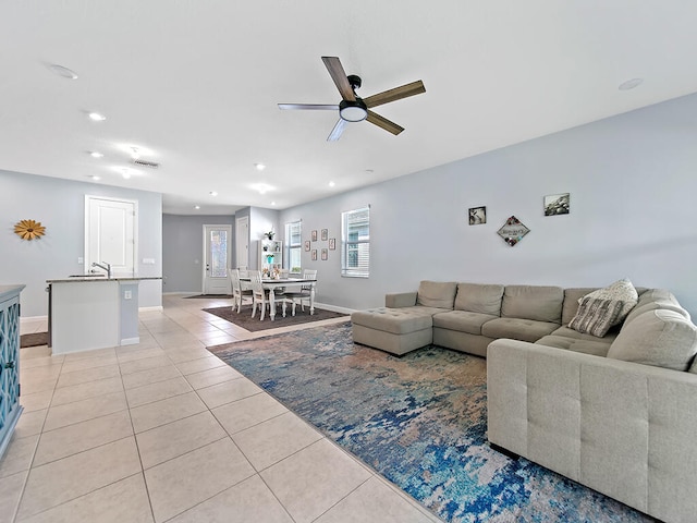 tiled living room with sink and ceiling fan