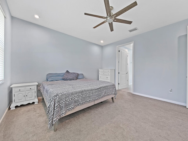 carpeted bedroom with multiple windows and ceiling fan