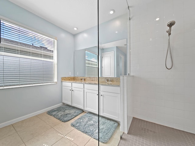 bathroom featuring vanity, tiled shower, a wealth of natural light, and tile patterned floors