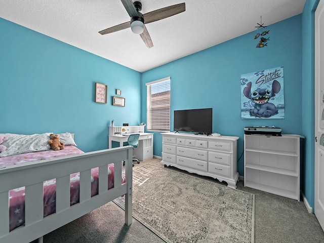 carpeted bedroom featuring a textured ceiling and ceiling fan