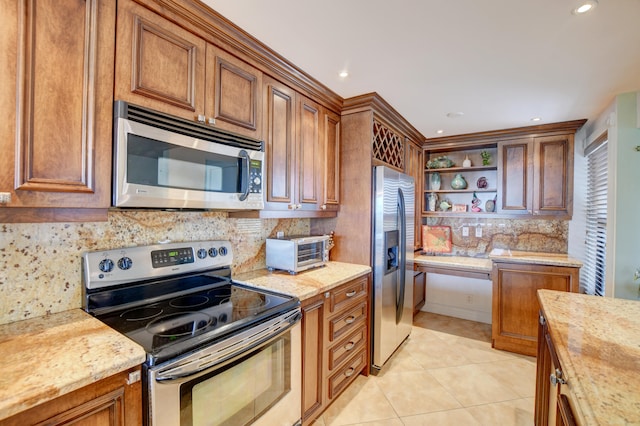 kitchen featuring stainless steel appliances, light stone countertops, light tile patterned floors, and decorative backsplash