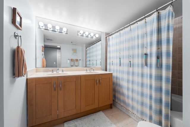 bathroom with tile patterned floors and vanity