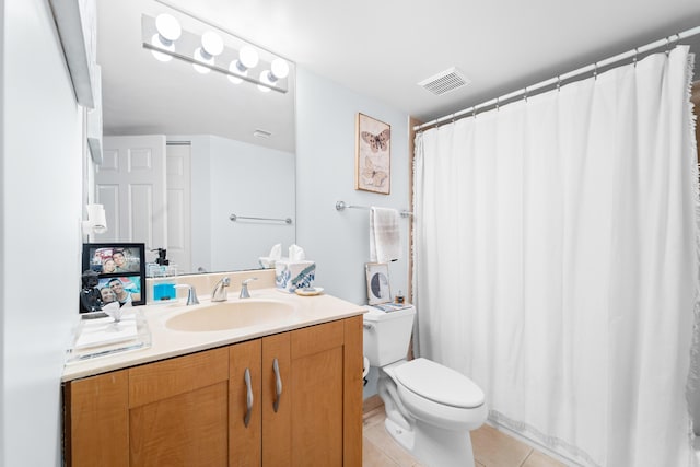 bathroom with tile patterned floors, vanity, and toilet