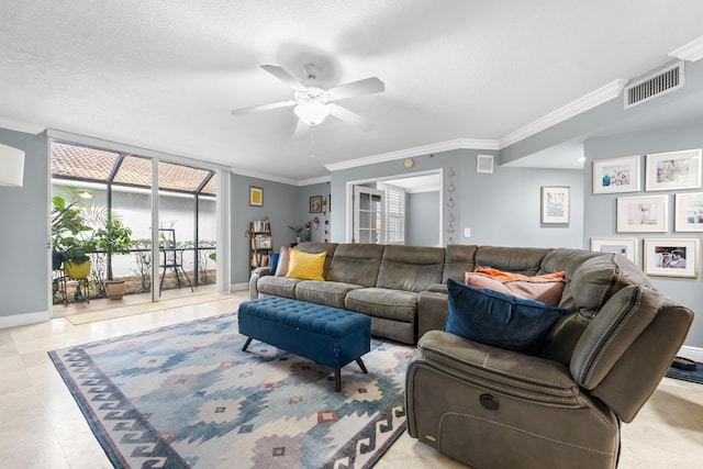 tiled living room with ceiling fan, ornamental molding, and a textured ceiling