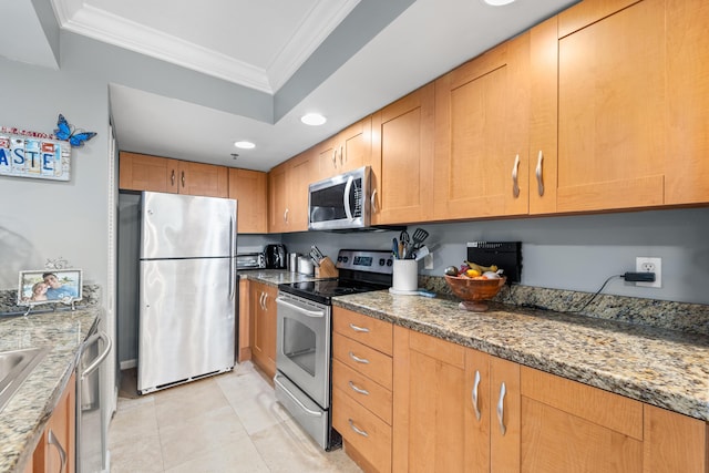 kitchen with stone counters, a raised ceiling, light tile patterned floors, ornamental molding, and stainless steel appliances