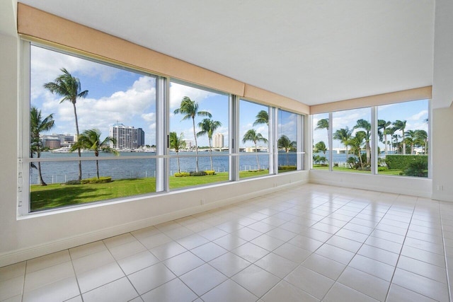 unfurnished sunroom featuring a wealth of natural light and a water view