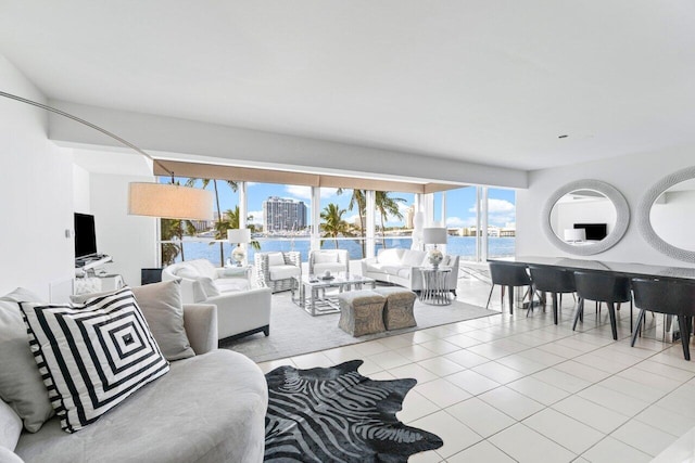 tiled living room featuring a water view