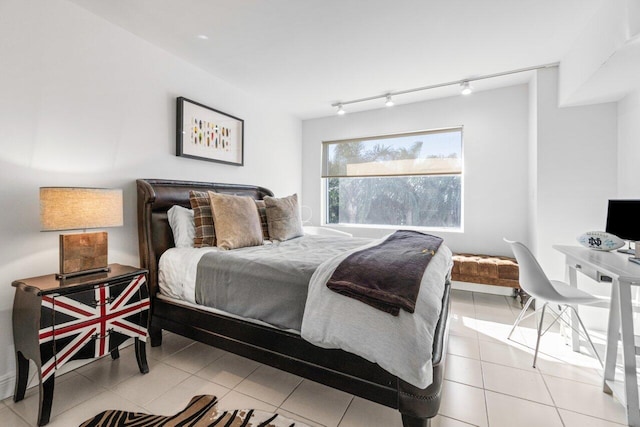 tiled bedroom featuring track lighting