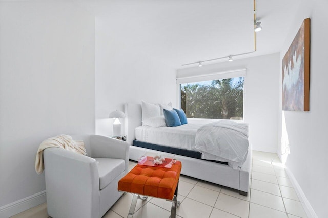 bedroom featuring rail lighting and light tile patterned floors