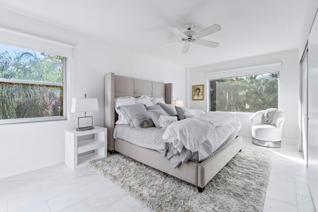 44 Cocoanut Row Unit 120B, Palm Beach, FL 33480 - bedroom with multiple windows, a ceiling fan, and baseboards