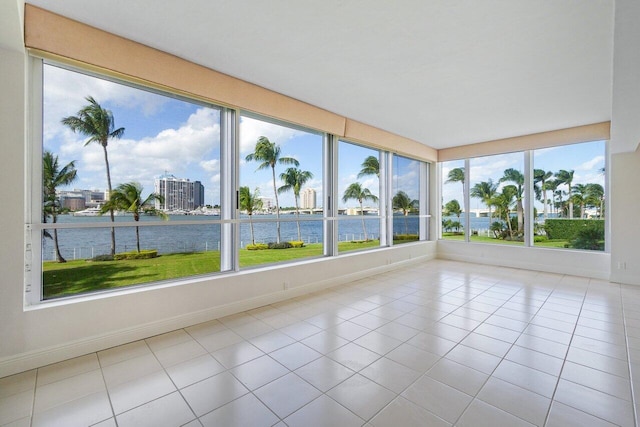 44 Cocoanut Row Unit 120B, Palm Beach, FL 33480 - unfurnished sunroom with a water view, tile patterned flooring, and baseboards
