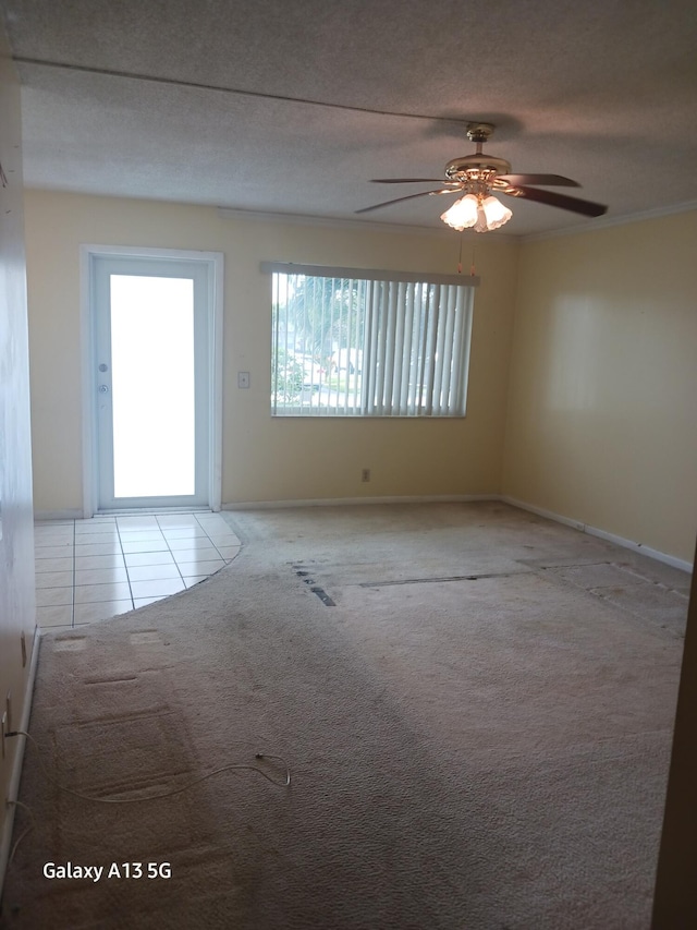 unfurnished room with light carpet, a textured ceiling, and ceiling fan