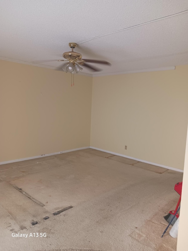 empty room featuring ornamental molding, a textured ceiling, carpet flooring, and ceiling fan