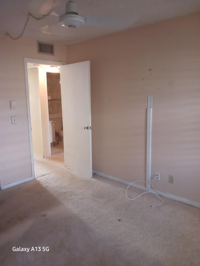 unfurnished bedroom with light colored carpet and ceiling fan